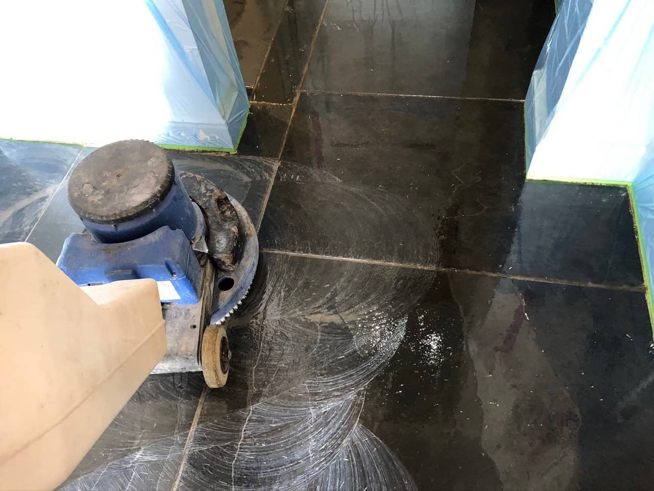 Wet slate floor during rinse and soil extraction after cleaning
